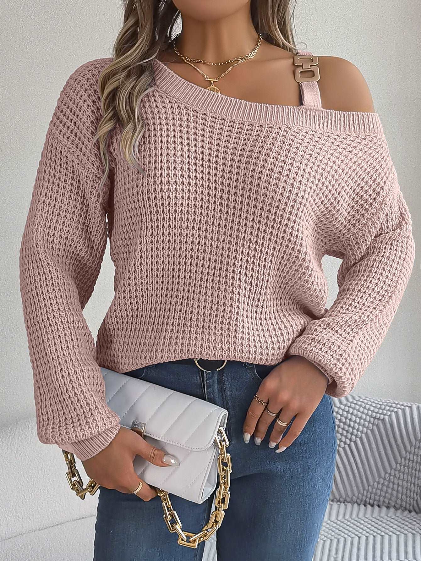 "Women's casual pullover sweater with metal buckle patchwork and cold-shoulder lantern sleeves."