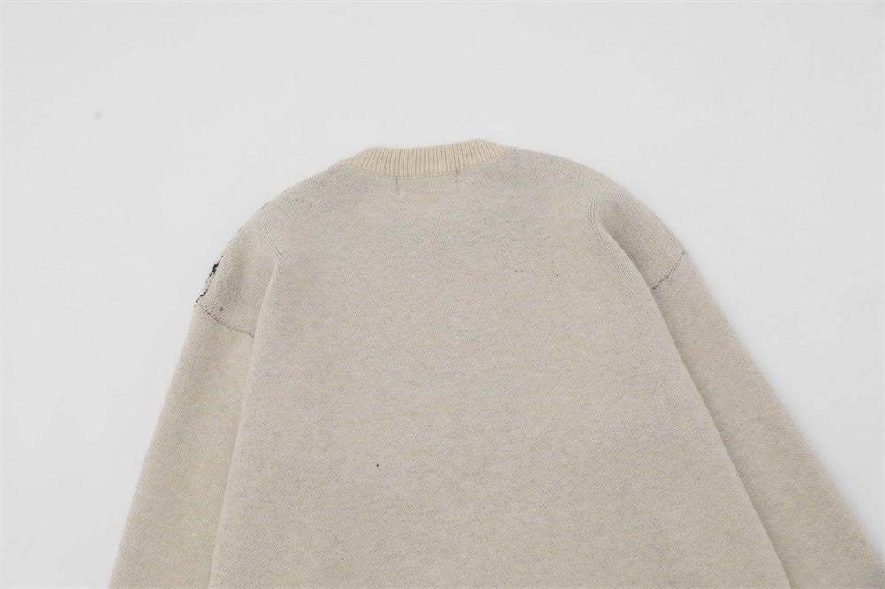 Men's sweater designed with a spider appliqué and a ripped fabric style