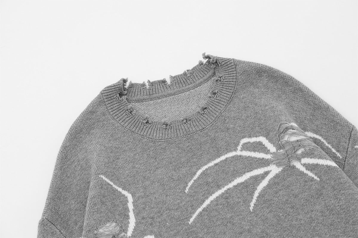 This stylish ripped sweater combines American street fashion with a unique spider design for an eye-catching and contemporary look