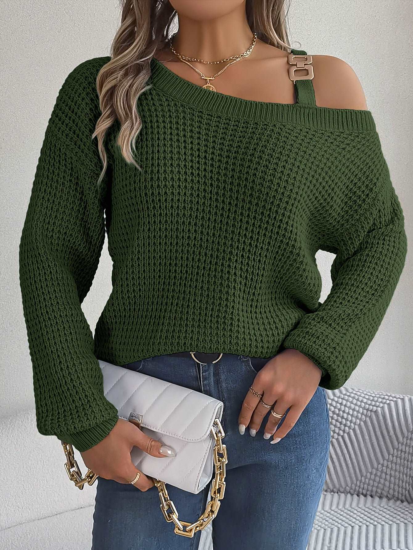 "Women's casual pullover sweater with metal buckle patchwork and cold-shoulder lantern sleeves."